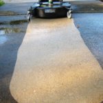 A Whisper Wash surface cleaner being used to pressure wash dirty concrete by Hot Water Pressure Washing & Soft Wash in Tallahassee, Florida.