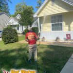 A soft washing service cleaning a vinyl siding home in Tallahassee, Florida, the home of a Florida State Seminoles fan.