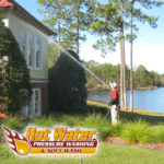 A professional pressure washer cleaning the exterior of a lakefront home near the Tallahassee/Thomasville border.