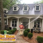 A worker uses a soft washing technique to clean the siding and windows of a two-story home in Tallahassee, Florida